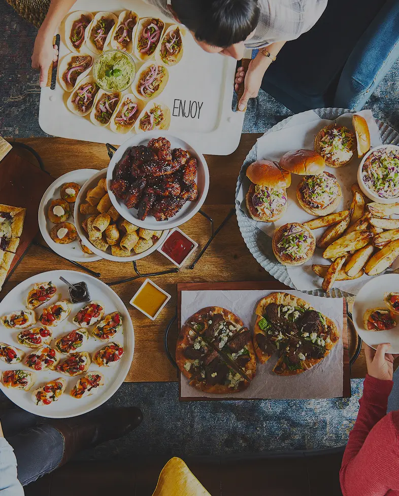 Overhead view of assorted Chef’d dishes arranged on a table for a food shoot.